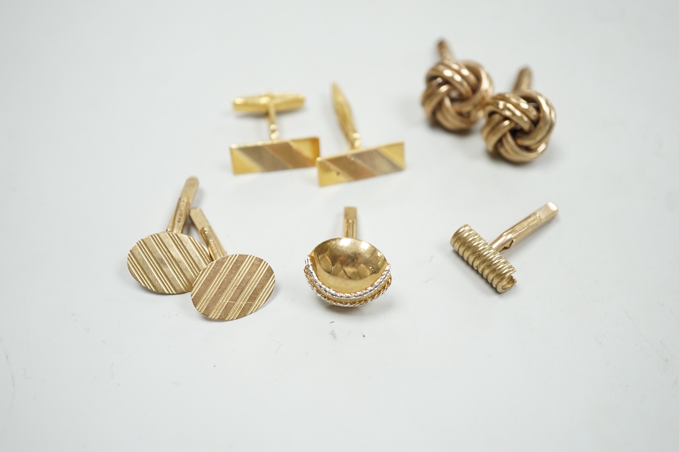 A modern three colour 750 pair of cufflinks, 9.2 grams, a pair of 9ct gold oval cufflinks one other 9ct gold pair and two odd 9ct gold cufflinks, 20.7 grams.